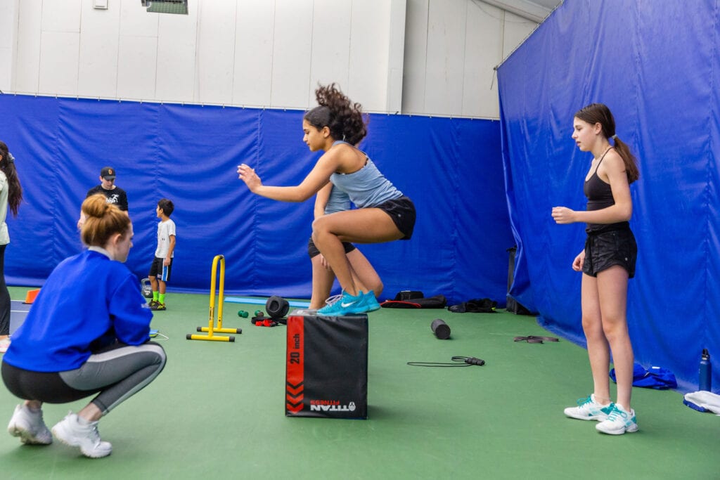 A girl getting jumping training in a training institute